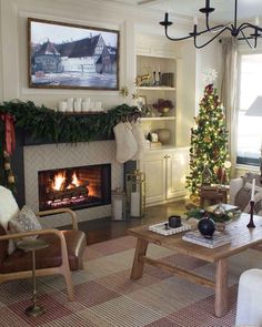 a living room filled with furniture and a fire place in front of a christmas tree