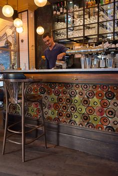 a man is behind the bar at a restaurant