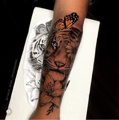 a person with a tiger and butterfly tattoo on their arm