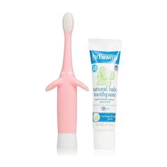 a pink toothbrush next to a tube of toothpaste on a white background