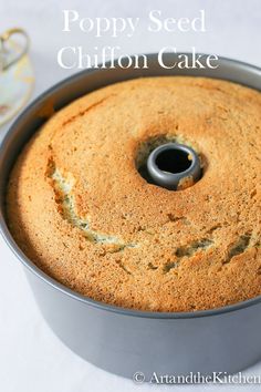 a cake in a metal pan with the words poppy seed chiffon cake above it