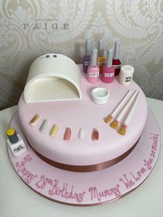 a birthday cake with makeup and nail polish on it