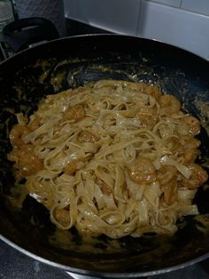 some noodles are being cooked in a skillet