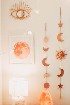 the sun, moon and stars are hanging on the wall