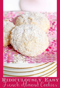 two powdered sugar cookies sitting on top of plates