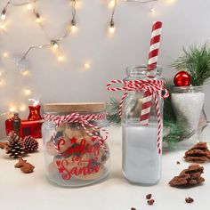 two jars filled with cookies next to christmas decorations