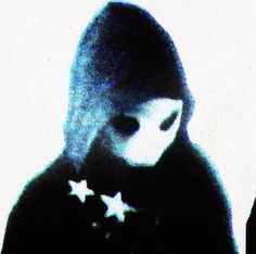 a blurry image of a woman with stars on her coat and hood over her face