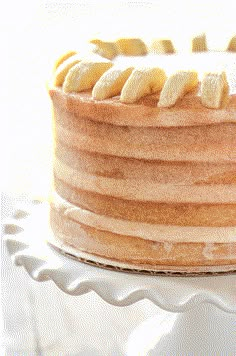 a close up of a cake with bananas on top