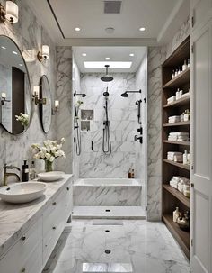 a bathroom with marble floors and white walls, along with two sinks and a large walk in shower