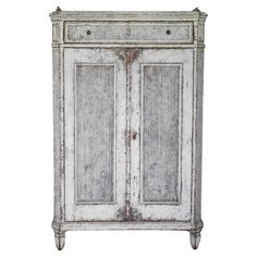 an old white cabinet with two doors