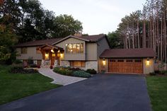 a large house in the evening with lights on