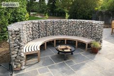 an outdoor seating area with stone walls and benches