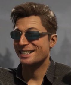 a man wearing sunglasses and smiling for the camera