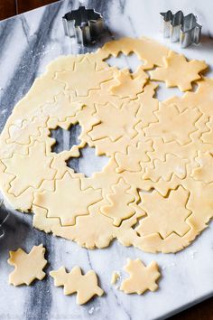 the cookie dough is ready to be cut and put into the shape of christmas cookies