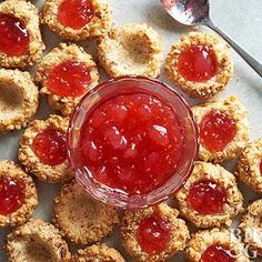 small cookies with jam in the middle on a table