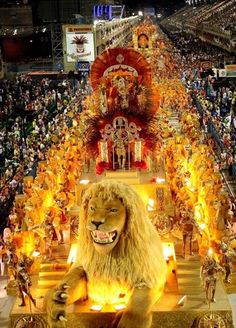 a lion costume on display in front of a crowd at a sporting event with flames coming out of its mouth