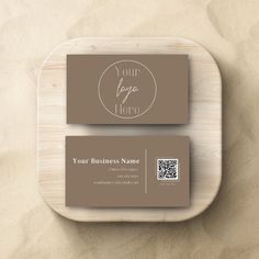 two business cards on a wooden plate with a qr code in the middle and a qr code at the bottom