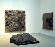 two paintings on display in a museum with one stone and the other is rock like material