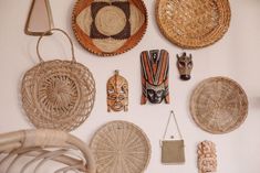 wicker baskets and other decorative items hang on the wall