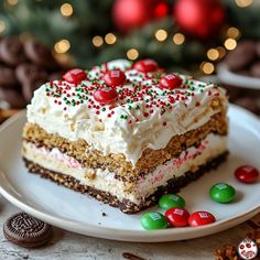 a piece of cake sitting on top of a white plate next to chocolate candies