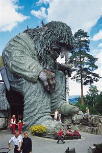 people are standing in front of a giant statue