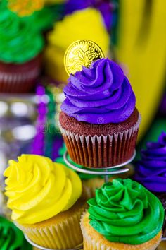 cupcakes with colorful frosting and a bitcoin on top stock photos