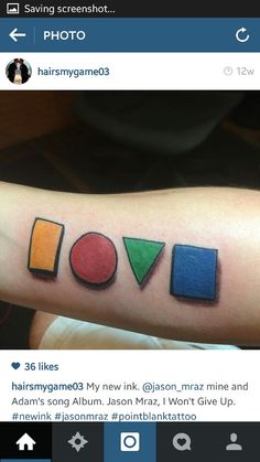 a person with a tattoo on their arm that has different colored shapes and words in it