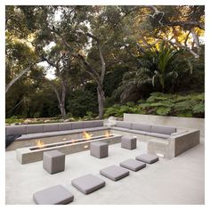 an outdoor seating area with benches and fire pit