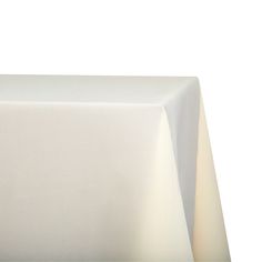 an empty white tablecloth on top of a wooden table