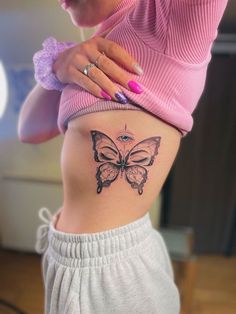 a woman's stomach with a butterfly tattoo on her belly and the bottom part of her lower body