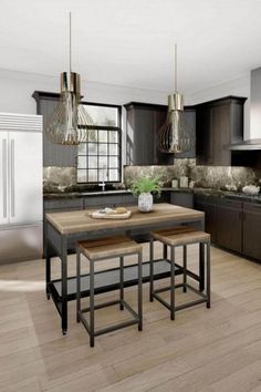 a large kitchen with wooden floors and black cabinets, an island in the middle is surrounded by two stools