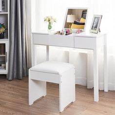 a white desk with a mirror and stool