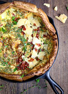 a quiche with cheese and herbs in a skillet