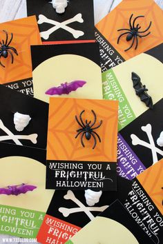 halloween greeting cards with fake bats and spider on them, all decorated in different colors