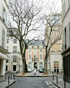 an empty street with cars parked on the side