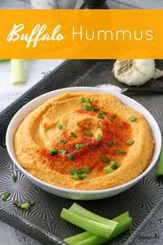 hummus in a bowl with celery on the side