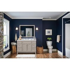 a bathroom with blue walls and white fixtures