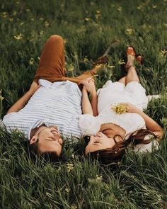 two people laying in the grass together