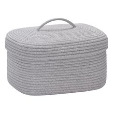 a grey storage basket with handles on the top and bottom, sitting against a white background