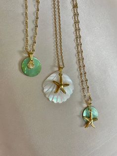 FREE UK DELIVERY FOR A LIMITED TIME ONLY.  18 karat gold plated seashell / starfish necklaces with natural shell and mother of pearl. 40-45cm All gold wear is stainless steel, water safe and resistant to tarnish.  Natural green Akoya shell & baby seashell charm (vintage style chain) Carved seashell mother of pearl with starfish charm (cable chain) Natural green Akoya shell with starfish charm (vintage style chain) Each shell is unique.  Items are dispatched within 2 working days and sent Royal M Gold Starfish Charm Necklace, Gold Shell Necklace With Starfish Charm As Gift, Starfish Shell Jewelry, Gold Shell-shaped Jewelry With Starfish Charm, Ocean-inspired Round Gold Necklace, Ocean-inspired Gold Charm Necklace For Gift, Gold Ocean-inspired Charm Necklace For Gift, Gold Ocean-inspired Charm Necklaces As Gift, Gold Starfish Shell Necklace