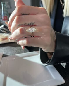 a close up of a person with a ring on their finger