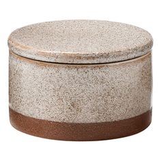 a brown and white container sitting on top of a table