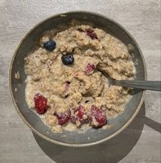 a bowl filled with oatmeal and berries