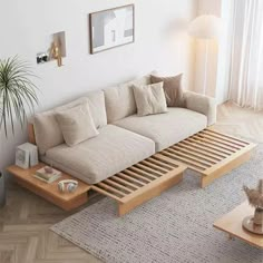 a living room with a white couch and wooden coffee table on the floor in front of a window