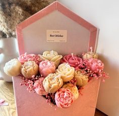 a bouquet of flowers in a pink box