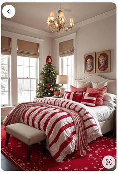 a bedroom decorated for christmas with red and white bedding