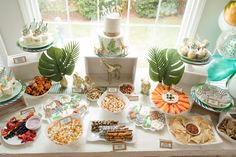 a table filled with lots of food and desserts