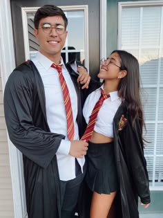 a man and woman dressed up in harry potter costumes, posing for a photo together