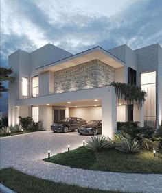 two cars are parked in front of a modern house at night with lights on the windows