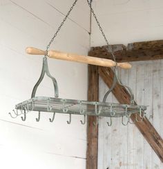 an old metal rack with hooks hanging from it